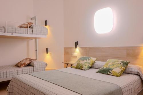 a bedroom with a bed and a couch at Hostal Castilla II Puerta del Sol in Madrid