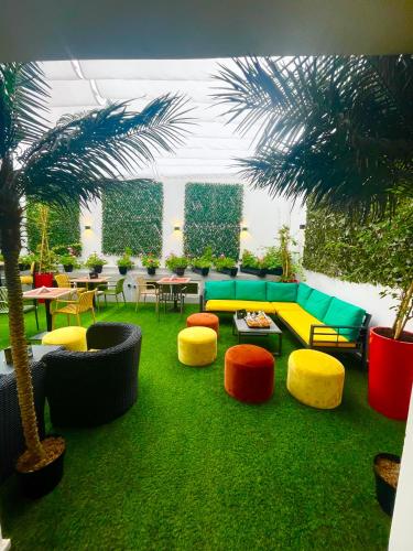 a living room with colorful furniture and palm trees at Rent-inn Boutique Hotel in Rabat