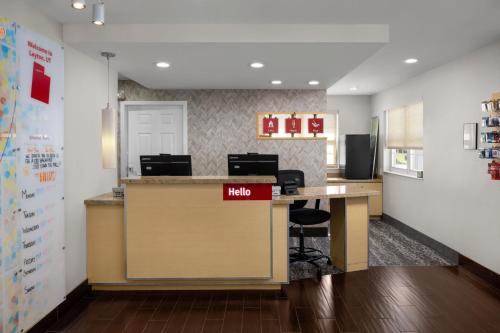 an office with a desk with a help sign on it at TownePlace Suites Salt Lake City Layton in Layton