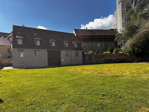 a large building with a grass field in front of it at Duplex confort exceptionnel hyper centre parking à proximité in Haguenau