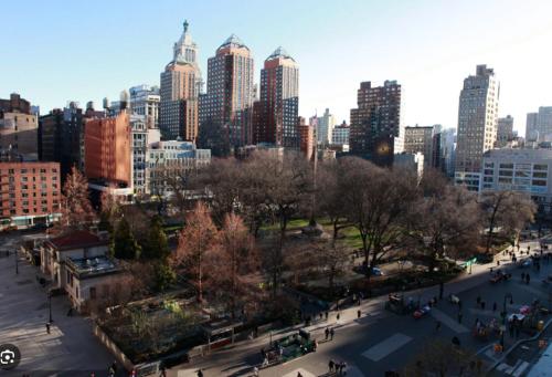 a view of a city with people walking in a park at Oasis Apartment in the Heart of Union Square Downtown Manhattan in New York