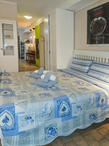 a blue and white bed with two chairs on it at Vado al teatro monolocale in centro per 2 in Ancona