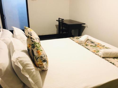 a bed with a pillow sitting on top of it at Bracedale Estate in Kegalle