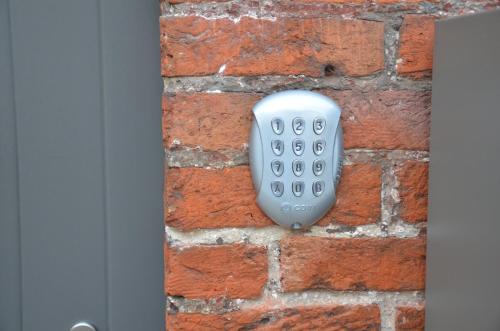 a remote control sitting on a brick wall at Apartment Sariks Place in Bruges