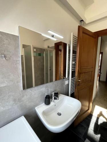 a bathroom with a white sink and a mirror at Arte in Mantova in Mantova