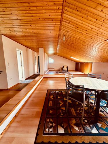 a dining room with a table and chairs in a room at Oliveira Guest House in Louredo