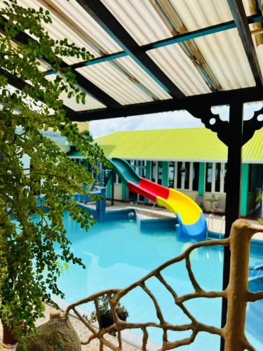 a swimming pool with a slide and a playground at Ribiera del Lago Peten Itza in Flores