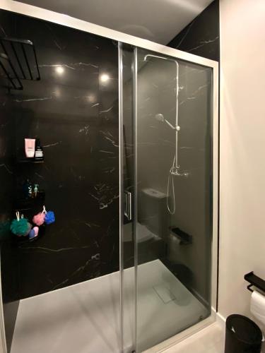 a shower with a glass door in a bathroom at Barra Azul - Beach Apartment in Praia da Barra