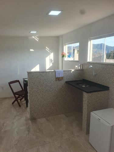 a kitchen with a counter with a sink in it at Mini Casa Monte Cielo in Miguel Pereira
