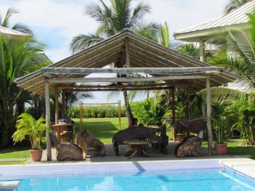 a gazebo with statues of animals sitting next to a pool at #17A Hermosa Beach Bungalow 1st floor 1 bedroom Apt in Playa Hermosa