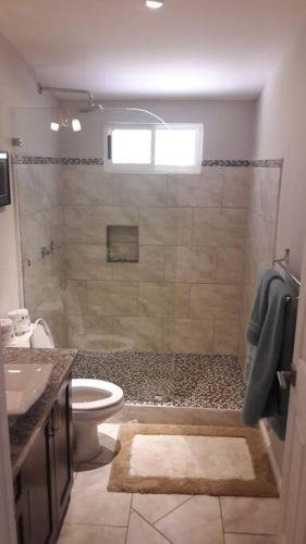 a bathroom with a shower with a toilet and a sink at #17A Hermosa Beach Bungalow 1st floor 1 bedroom Apt in Playa Hermosa