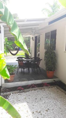 a patio with a table and chairs and plants at #17A Hermosa Beach Bungalow 1st floor 1 bedroom Apt in Playa Hermosa
