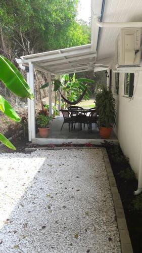 a porch of a house with a table and chairs at #17A Hermosa Beach Bungalow 1st floor 1 bedroom Apt in Playa Hermosa