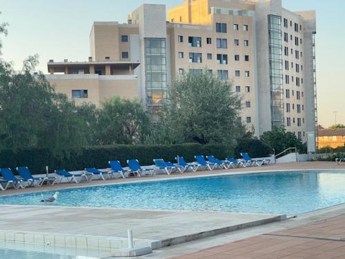 a swimming pool with lounge chairs and a building at BestHomeStay- Lisbon- Garden, Pool & Garage in Lisbon