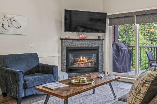 a living room with a fireplace and a tv at Outstanding Mountain Condo WATERSLIDE and HOT TUB managed by Little Sister Getaways in Canmore