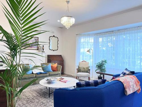 a living room with a blue couch and a table at Sunny Retro Home Burnside area in Rose Park