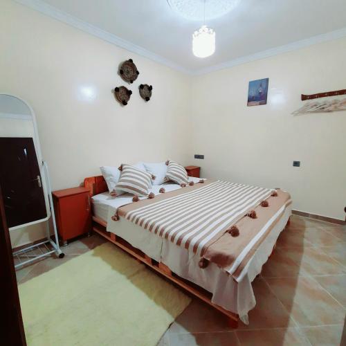 a bedroom with a large bed in a room at Azour House in Taghazout