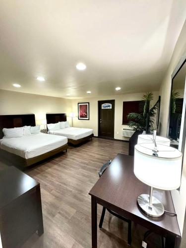 a hotel room with two beds and a table at Americas Best Value Inn Marquette in Marquette