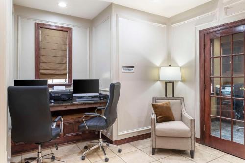 an office with a desk with a computer and a chair at Best Western Plus Crown Colony Inn & Suites in Lufkin