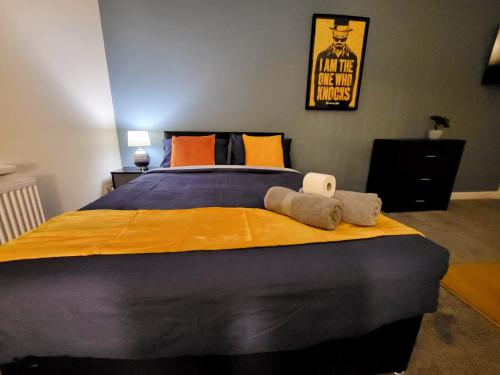 a bedroom with a large bed with a yellow blanket at Stay Sleep Rest - Oldham in Oldham