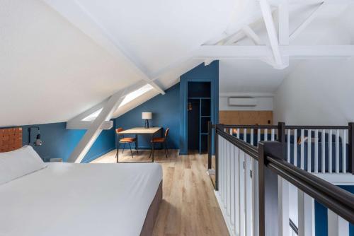 a bedroom with a bed and a table on a balcony at Best Western Bridge Hotel Lyon East in Jons