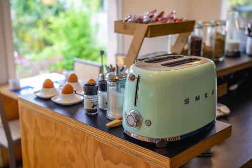 a toaster sitting on top of a table with eggs at Best Western Bridge Hotel Lyon East in Jons
