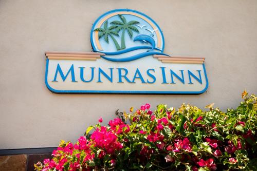 a sign on the side of a building with flowers at Munras Inn in Monterey