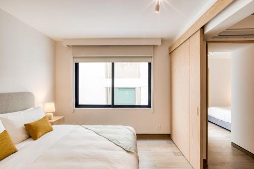a bedroom with a bed and a window at TONALA By Mr W in Mexico City