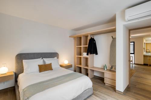 a bedroom with a large white bed and a hallway at TONALA By Mr W in Mexico City