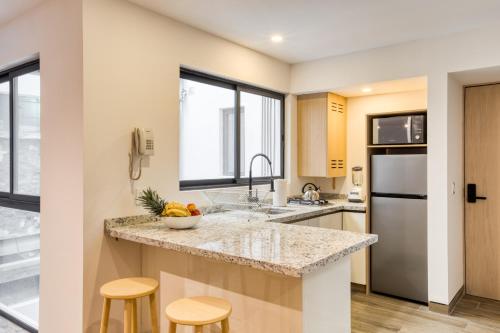 a kitchen with a counter top and a refrigerator at TONALA By Mr W in Mexico City
