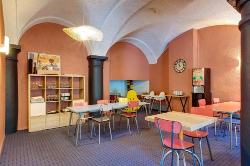 a library with tables and chairs and a clock at Sure Hotel by Best Western Annecy in Annecy