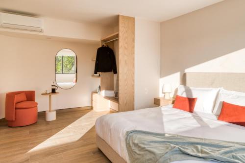 a bedroom with a bed and a chair and a mirror at TONALA By Mr W in Mexico City