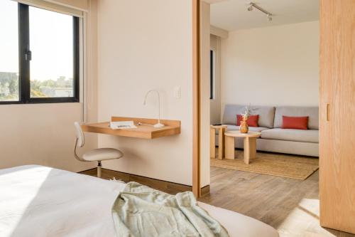 a bedroom with a bed and a desk and a couch at TONALA By Mr W in Mexico City