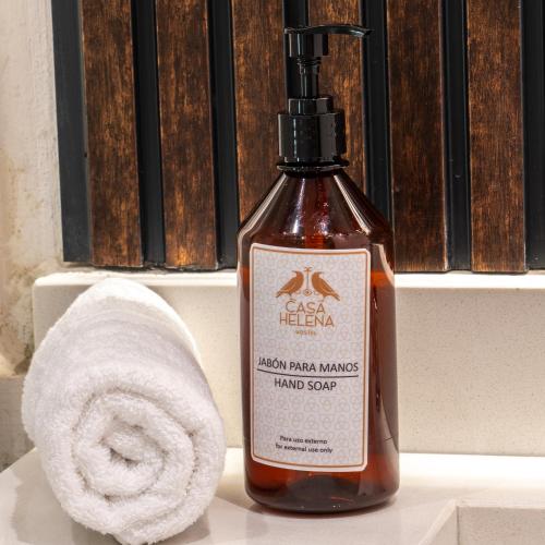 a bottle of soap sitting next to a towel at Casa Helena Hostel in Cartagena de Indias