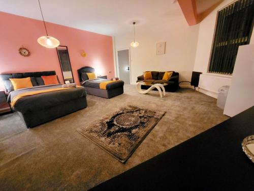 a large living room with a bed and a couch at Stay Sleep Rest - Oldham in Oldham