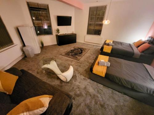 a large living room with a couch at Stay Sleep Rest - Oldham in Oldham