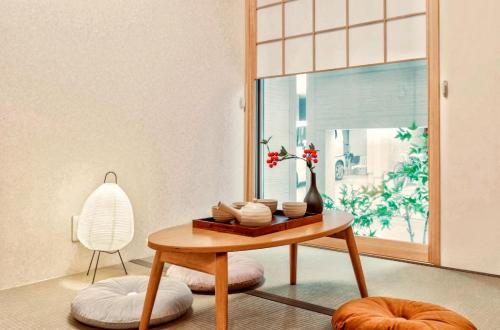 a living room with a table and a window at Japanese Bath House 5min to Namba Free Parking101 in Osaka