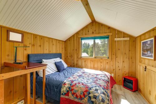 a bedroom with a bed in a wooden room at Cabin on 5 Acres in Port Angeles with Fire Pit! in Port Angeles