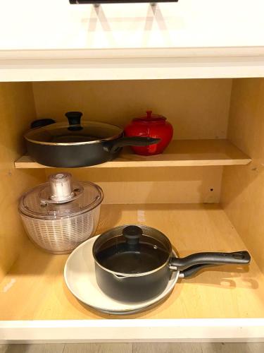 a shelf with a frying pan and other kitchen utensils at NEW cozy beautiful house with pool and hot tub in Fair Oaks