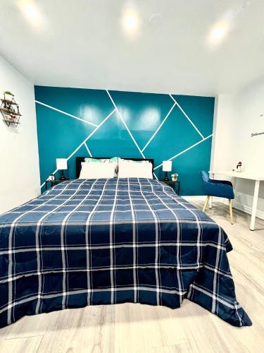 a blue bedroom with a bed and a blue wall at Private Room Near Airport K7 in Mississauga