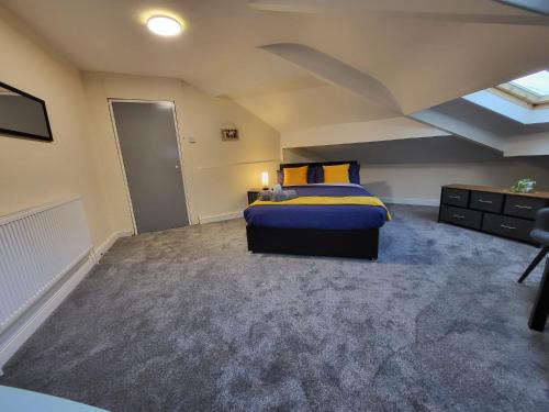 a bedroom with a bed in a room with a ceiling at Stay Sleep Rest - Oldham in Oldham