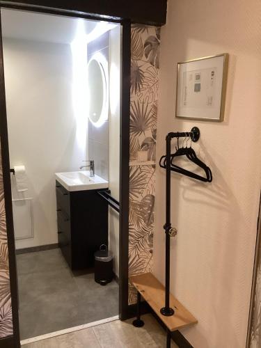 a small bathroom with a sink and a shower at AUBERGE DE LA VOUTE in Chooz