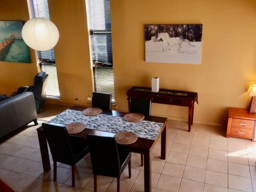 a dining room with a table and a desk at Questro Breeze in Kalbarri