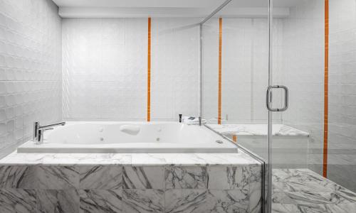 a white bathroom with a tub in a room at Flamingo Las Vegas Hotel & Casino in Las Vegas