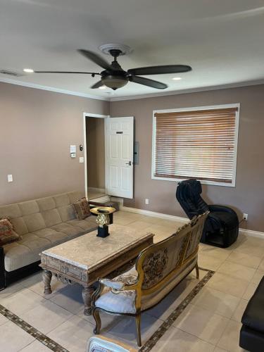 a living room with a couch and a ceiling fan at paradise luxury experience in Woodland Hills