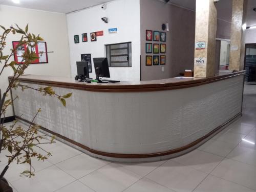 a reception counter in a hospital lobby with at Hotel Lisboa II in São José dos Campos