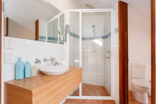 a bathroom with a sink and a toilet at Bathers Beach Loft Rooftop Views in Fremantle