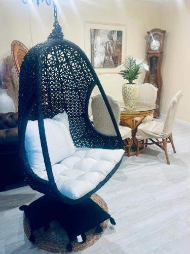 a black swing chair in a living room at La Villa Néoma in Saint-Pierre