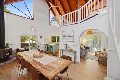 a dining room and living room with a table and chairs at Cooinda Inverloch in Inverloch