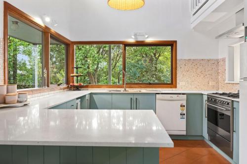 a kitchen with a white counter and a window at Cooinda Inverloch in Inverloch